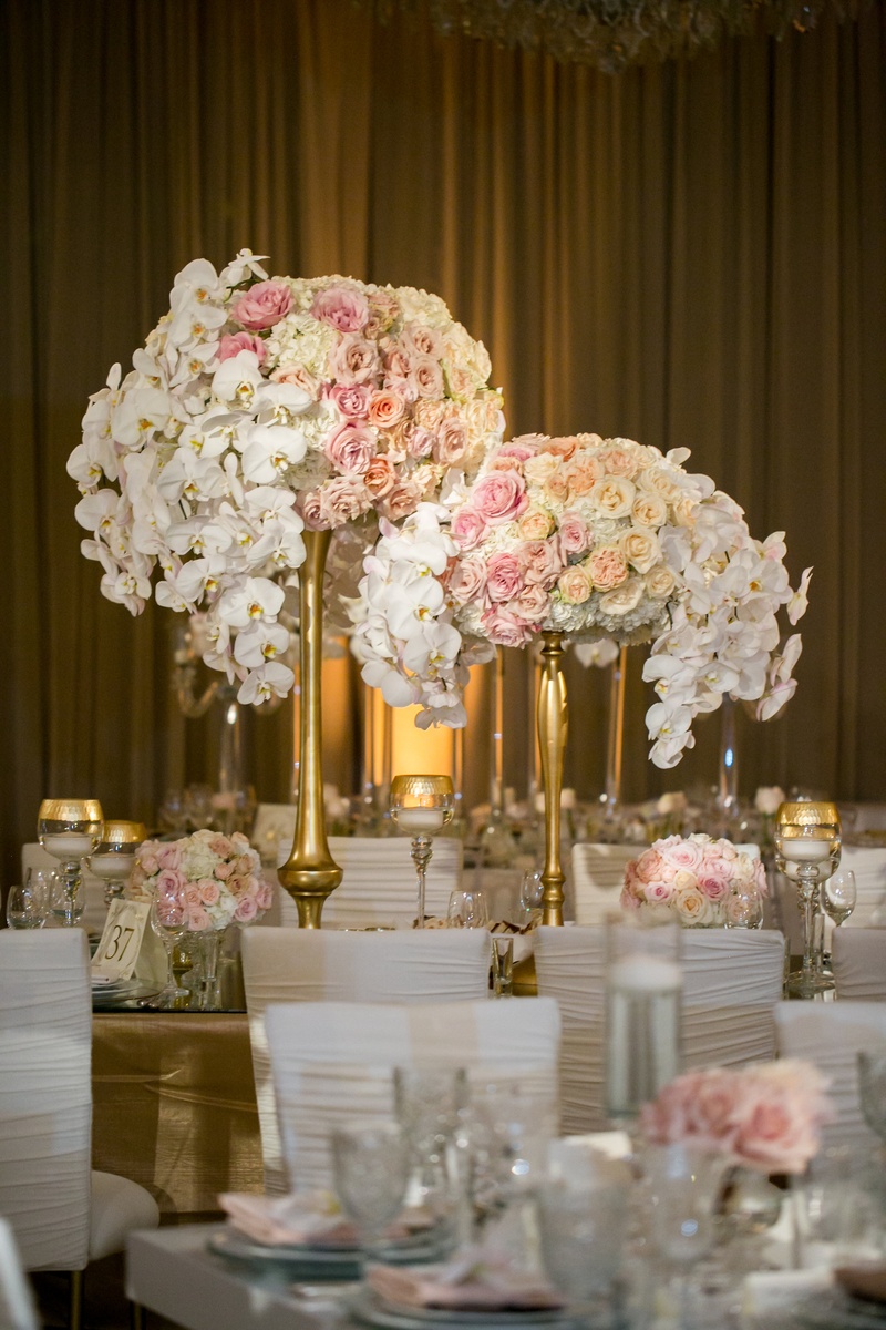 Lush Centerpieces on Gold Stands
Photography: Jessica Claire Photography
Read More:
http://www.insideweddings.com/weddings/traditional-armenian-ceremony-luxurious-ballroom-reception/1006/ centerpieces with white orchids, blush, cream, and peach roses, gold stands