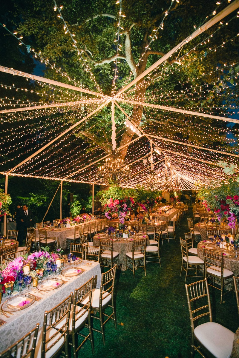 Twinkle Light Tent for Vibrant Reception
Photography: Mi Belle Photographers
Read More:
http://www.insideweddings.com/weddings/colorful-outdoor-wedding-with-supper-club-theme-in-los-angeles-ca/741/ Gold and white wedding linens with purple, pink, and red flower centerpieces