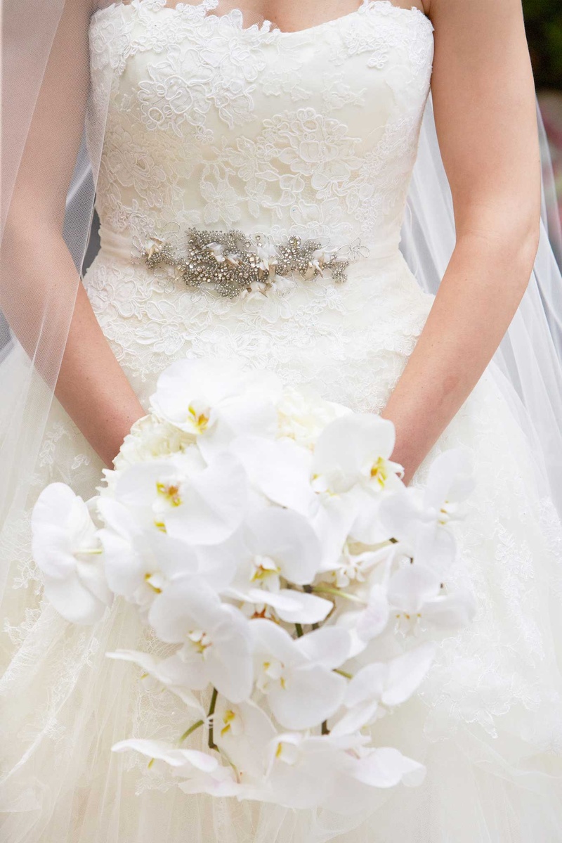 Bride's Bouquet of Cascading White Orchids
Photography: KingenSmith
Read More:
http://www.insideweddings.com/weddings/delicately-detailed-chicago-wedding-with-jewish-christian-customs/762/ bride holds cascading bouquet of white orchids in her white bridal ball gown vera wang