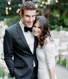 Jenna Gurnick %26 Kelly Ross
Photography: Amy %26 Stuart Photography
Read More:
http://www.insideweddings.com/weddings/rustic-elegant-outdoor-ceremony-luxe-garden-inspired-reception/869/ Groom in black and white tuxedo with bow tie smiling with bride in Marchesa wedding dress
