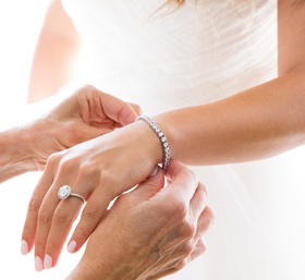 Bride with Tennis Bracelet
Photography: Duke Photography
Read More:
http://www.insideweddings.com/weddings/jewish-ceremony-classic-ballroom-reception-in-beverly-hills/922/ mother of the bride puts diamond tennis bracelet on bride