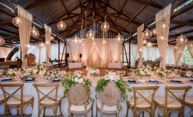 Barn Wedding with Rustic-Chic Chairs
Photography: Willa Kveta Photography
Read More:
http://www.insideweddings.com/weddings/alfresco-ceremony-by-the-beach-elegant-barn-wedding-reception/1298/ wedding reception head table over dance floor orb pendant twinkle light strands cane vineyard chairs