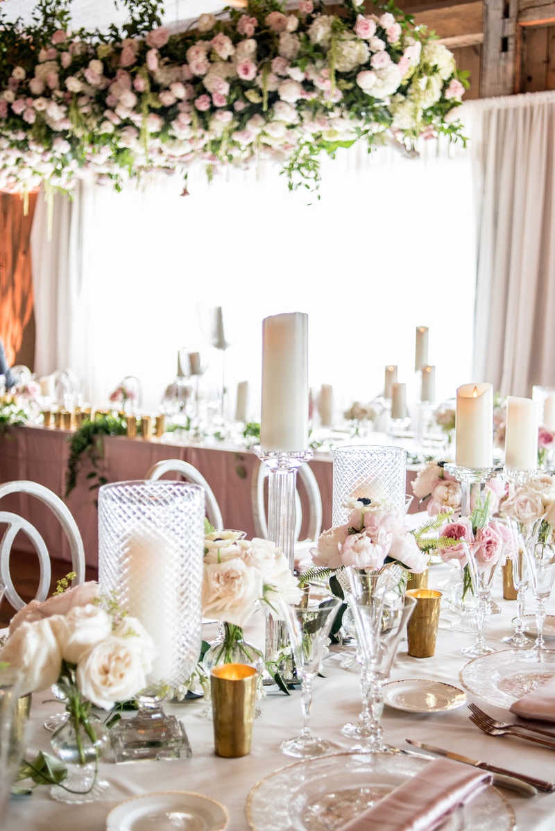 Pillar Candles on Display
Photography: Little Tree Studios
Read More:
http://www.insideweddings.com/weddings/brian-winters-of-the-new-york-jets-romantic-rustic-chic-wedding/1245/ reception tables with pillar candles in textured hurricanes and on stands