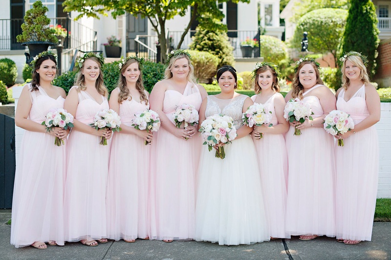 Pink Bridesmaid Gowns with Different Necks
Photography: Kortnee Kate Photography
Read More:
http://www.insideweddings.com/weddings/hometown-celebration-with-rustic-details-colorful-pastel-flowers/1035/ Bride with seven bridesmaids pale pink gowns mismatched necklines matching bouquets greenery crowns