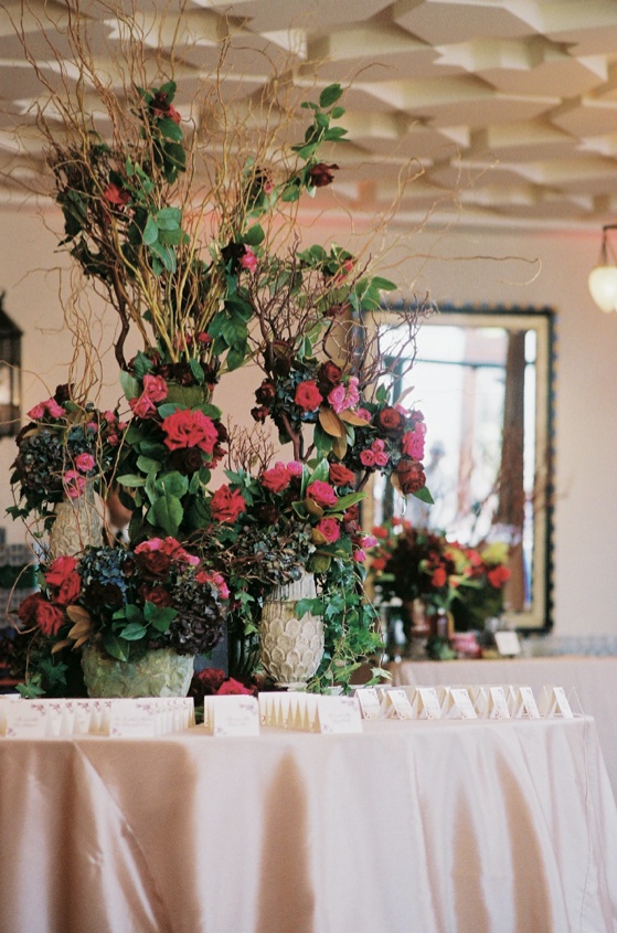 Tall Escort Card Display
Photography: John Solano Photography
Read More:
http://www.insideweddings.com/weddings/summertime-wedding-with-deep-red-hues-in-ojai-valley-california/240/ Branches and flowers in vintage vases on table