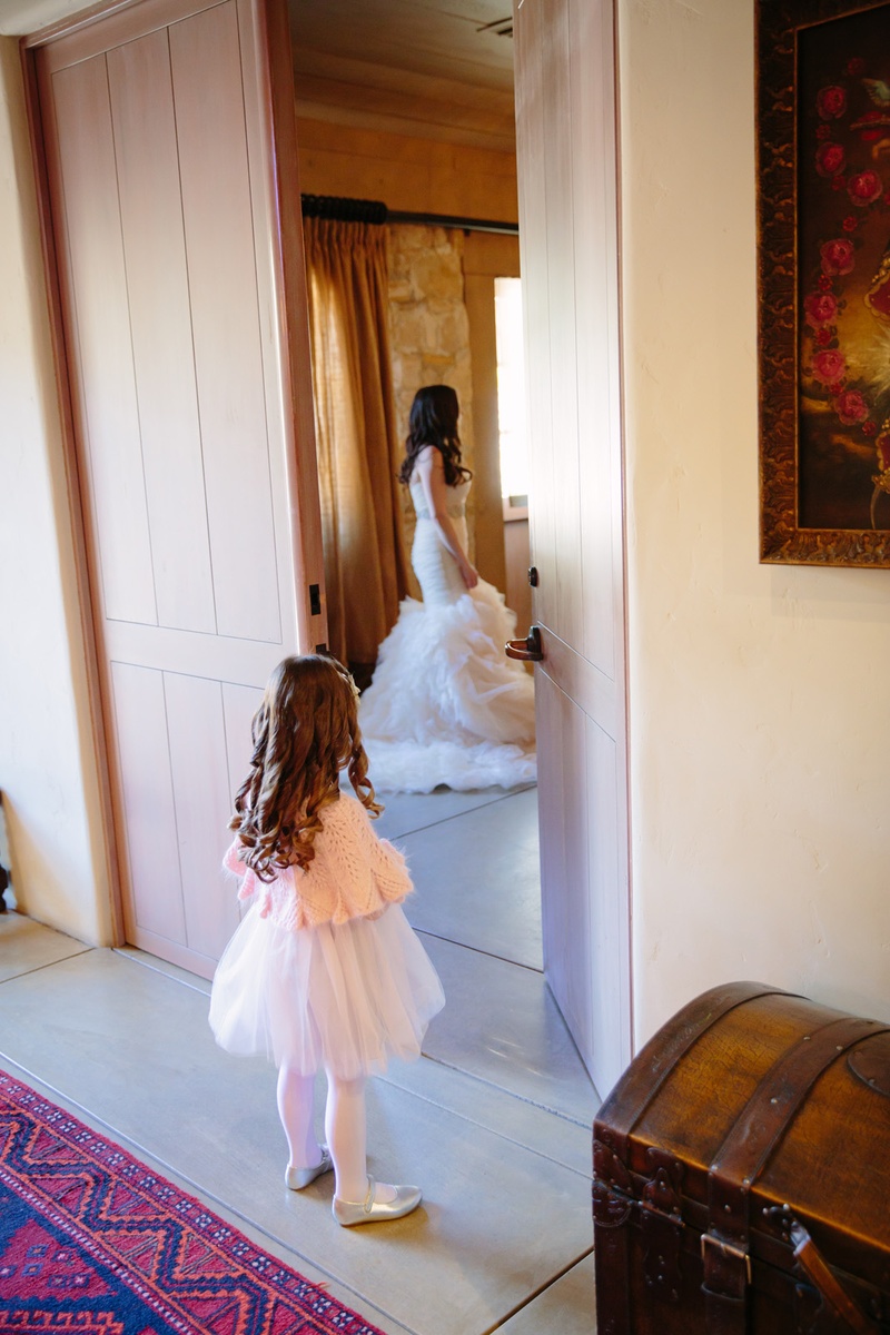 Flower Girl Watches Bride
Photography: Karlisch Photography
Read More:
http://www.insideweddings.com/weddings/modern-rustic-wedding-full-of-flowers-and-geometric-details/906/ flower girl in pink cardigan, tulle skirt, looks at bride