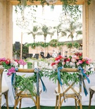 Ribbons %26 Greenery on Couple's Chairs
Photography: Bryan Miller Photography
Read More:
http://www.insideweddings.com/weddings/church-ceremony-tropical-outdoor-reception-in-san-diego/1192/ wedding reception bride groom chairs decorated with ribbon and greenery pink centerpieces tropical