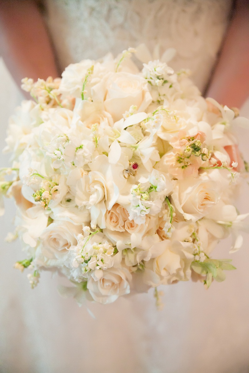 White and Ivory Bouquet with Jewel
Photography: Michael Carr Photography
Read More:
http://www.insideweddings.com/weddings/traditional-church-ceremony-forest-inspired-reception-in-houston/695/ White ranunculus, rose, peony bouquet with ruby ring