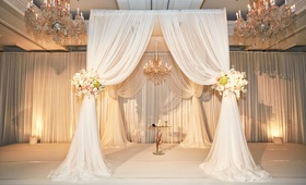 White Drapery Chuppah %26 Chandelier
Photography: KingenSmith
Read More:
http://www.insideweddings.com/weddings/elegant-wedding-with-blush-ivory-and-gold-palette-in-chicago/769/ Jewish wedding ceremony in Chicago with white drapes, flower tie backs with roses, chandeliers