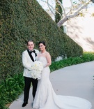 Bride and Groom Beside Hedge Wall
Photography: Kristina Lee Photography
Read More:
http://www.insideweddings.com/weddings/black-and-white-wedding-with-modern-mixed-metals-in-los-angeles/1009/ bride in martina liana trumpet gown with illusion neckline and sleeves, groom in white tuxedo jacket