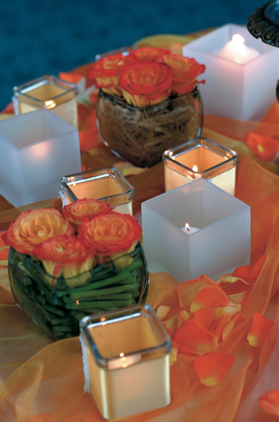 Orange Reception Decorations
Photography: Lifetime Images (Steven Schlesinger)
Read More:
http://www.insideweddings.com/weddings/formal-black-tie-wedding-in-la-jolla-california/52/ Orange flowers in vases and votive candles