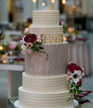 Five-Layer Cake with Dark Flowers
Photography: Kent Drake Photography
Read More:
http://www.insideweddings.com/weddings/an-event-planners-wedding-at-a-museum-by-sue-the-tyrannosaurus-rex/955/ Tall white wedding cake with middle tier in grey and dark flowers gold monogram
