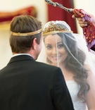 Couple During Rite of Crowning Ceremony
Photography: Sakosan Photography
Read More:
http://www.insideweddings.com/weddings/armenian-wedding-with-church-ceremony-blush-white-reception/809/ Bride smiling during rite of crowning tradition at Armenian wedding ceremony gold crown green red