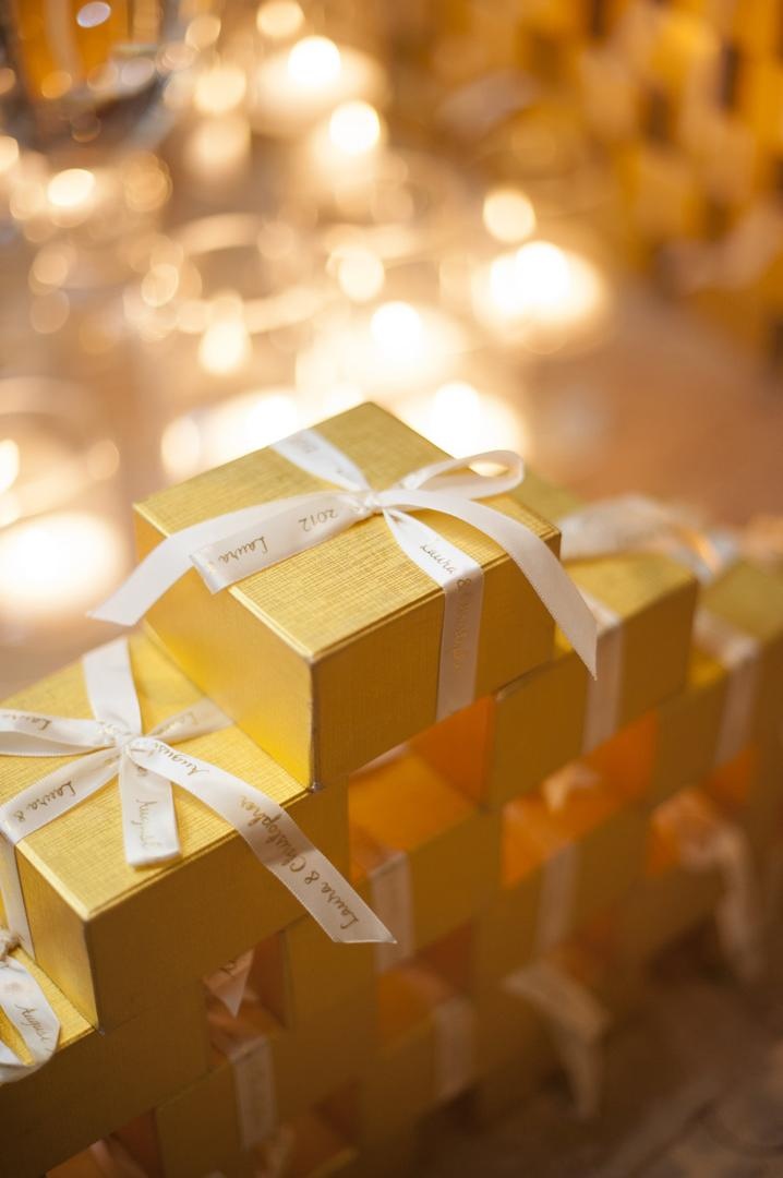 Gold Gift Boxes
Photography: Justin Marantz
Read More:
http://www.insideweddings.com/weddings/unforgettable-miami-wedding-with-acrobats-tiger-cubs-fireworks/437/ Personalized ribbon on gold wedding favor boxes