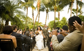 Palm Tree Ceremony Location
Photography: Melissa Mermin | Love Stories
Read More:
http://www.insideweddings.com/weddings/fall-country-club-wedding-in-naples-florida/347/ African American bride and groom walk up aisle guests take photos