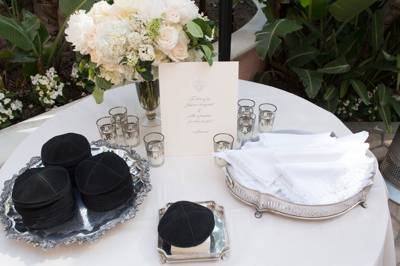 Yarmulkes %26 Handkerchiefs at Beverly Hills Wedding
Photography: John Solano Photography
Read More:
http://www.insideweddings.com/weddings/an-opulent-garden-ceremony-ballroom-reception-in-beverly-hills/986/ Silver platter of yarmulke black and white handkerchief at outdoor Jewish wedding ceremony