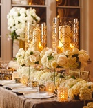 Raised Candle Displays
Photography: J. Cogliandro Photography
Read More:
http://www.insideweddings.com/weddings/angela-mecca-and-owen-daniels/540/ White hydrangea runner and gold-rimmed hurricanes