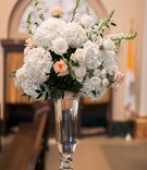 Vanilla %26 Sherbet Floral Design at Ceremony
Photography: Arte De Vie
Read More:
http://www.insideweddings.com/weddings/traditional-church-ceremony-country-club-reception-in-new-orleans/719/ Bouquet of white hydrangeas, roses, snapdragons, and light orange roses in a tall glass vase