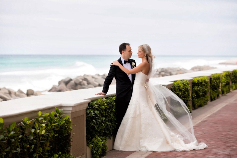 Bride %26 Groom on Walkway at The Breakers
Photography: Muñoz Photography
Read More:
http://www.insideweddings.com/weddings/colorful-jewish-ceremony-ballroom-reception-at-the-breakers/818/ Bride in strapless Vera Wang wedding dress and veil with groom in tuxedo looking over beach
