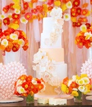 Towering Cake with Merengue Treats
Photography: Melody Melikian Photography
Read More:
http://www.insideweddings.com/weddings/stylish-bridal-shower-with-pops-of-punchy-shades-lovely-florals/989/ Tall cake with sugar flowers on dessert table decorated with poppy flowers and drapes behind