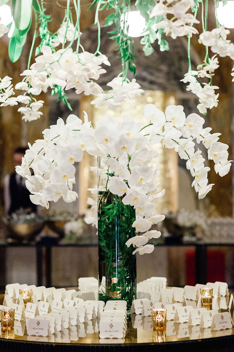 Orchids on Escort Card Table
Photography: Cornelia Lietz Photography
Read More:
http://www.insideweddings.com/weddings/fairy-tale-wedding-abroad-at-castle-in-grooms-hometown-in-germany/1374/ wedding reception in germany hotel venue white orchid greenery overhead vase die cut cards