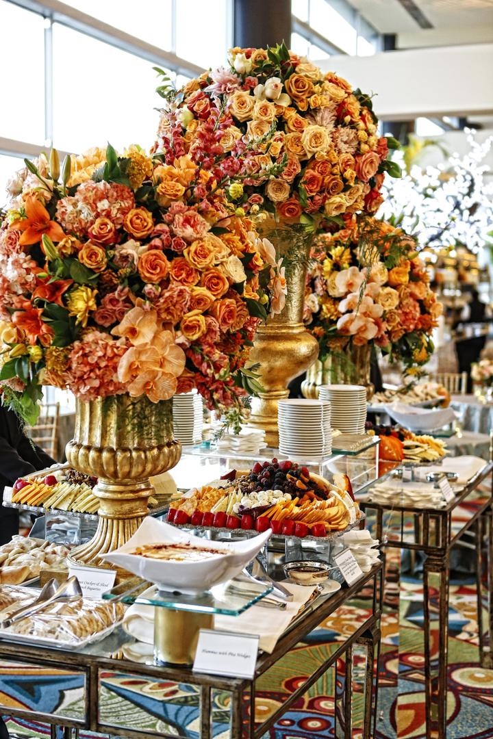 Appetizer Table
Photography: Tomas Ramos Photographers
Read More:
http://www.insideweddings.com/weddings/houston-indian-wedding-celebration-with-800-person-guest-list/435/ Appetizer table decorated with large golden urns filled with yellow, orange, and red flowers