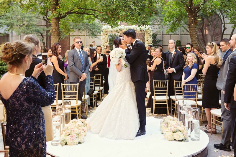 Bride and Groom Share Ceremony Kiss
Photography: Perez Photography
Read More:
http://www.insideweddings.com/weddings/persian-american-ceremony-with-light-hued-reception-in-dallas/841/ bride and groom share kiss platform in middle of outdoor aisle low roses after vows