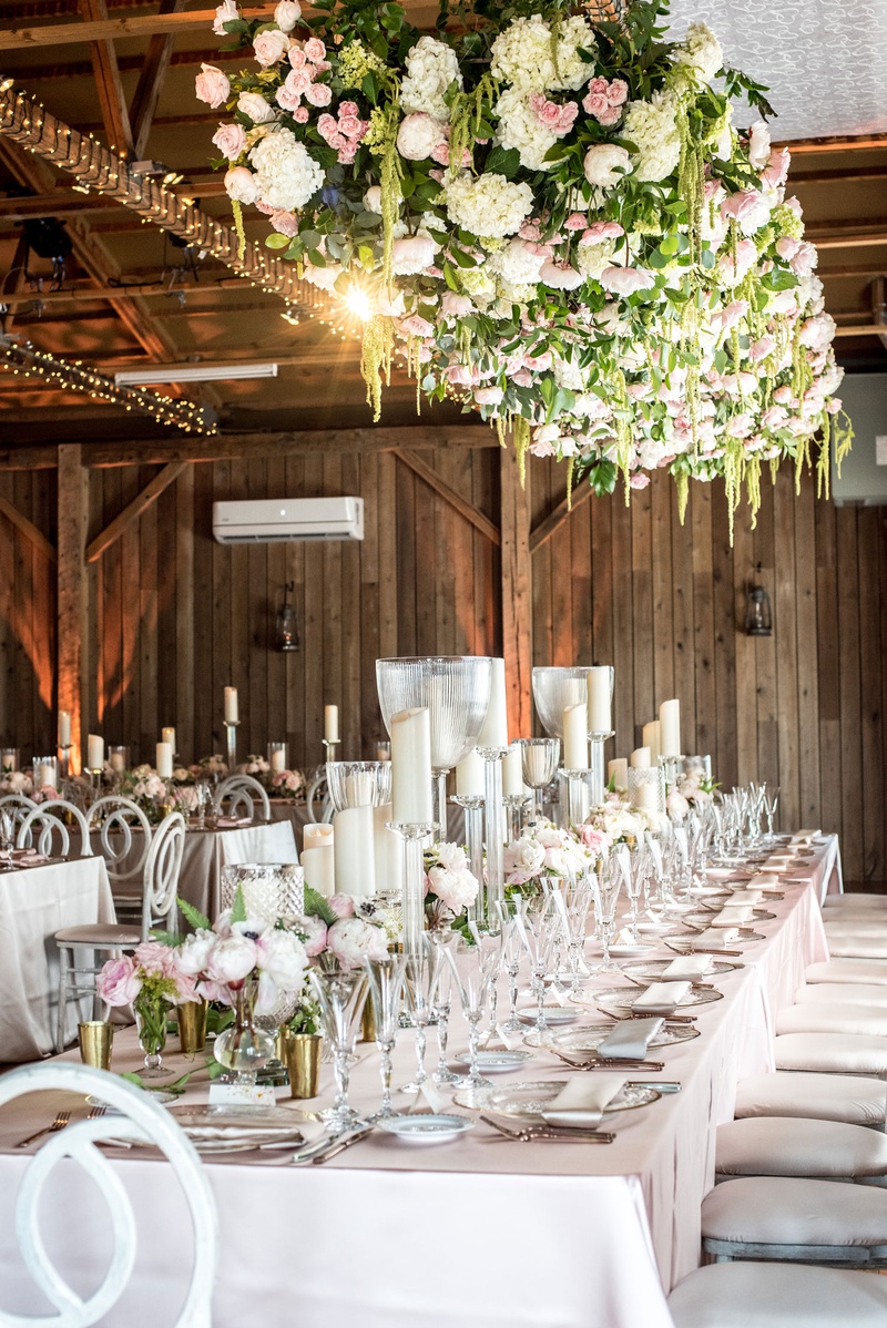 Floral Installation Above Table
Photography: Little Tree Studios
Read More:
http://www.insideweddings.com/weddings/brian-winters-of-the-new-york-jets-romantic-rustic-chic-wedding/1245/ rustic-chic barn wedding reception, floral installation over tables
