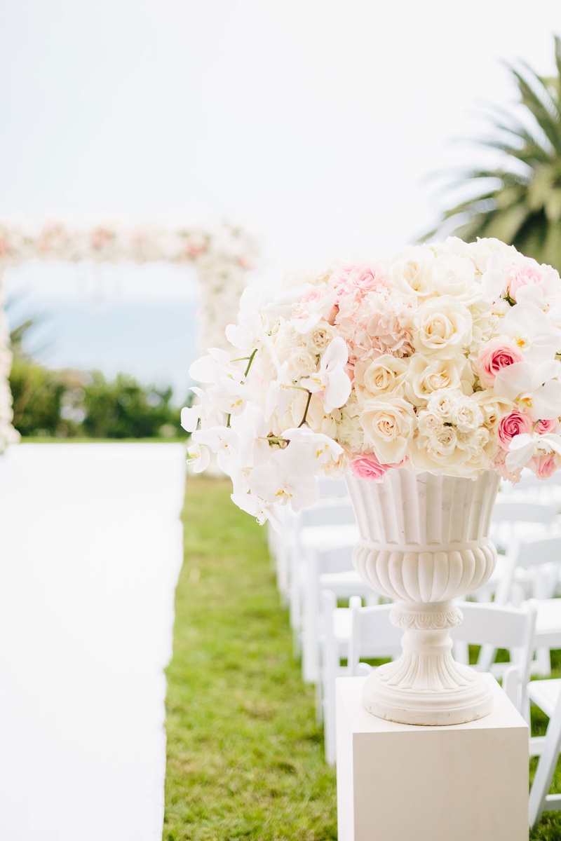Urn with Roses %26 Orchids at Ceremony
Photography: Jodee Debes Photography
Read More:
http://www.insideweddings.com/weddings/elegant-alfresco-ceremony-reception-with-parisian-elements/1176/ Wedding ceremony bluff ocean view pink white flowers pink rose white rose orchids
