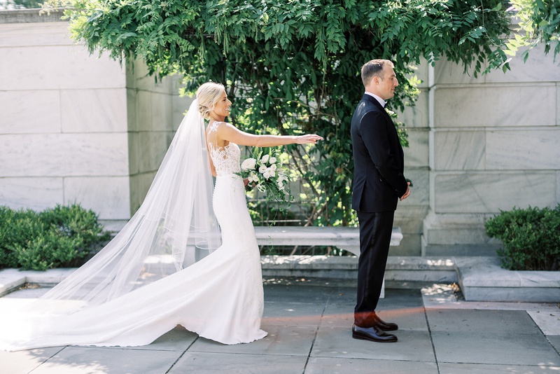 Bride About to Tap Groom at "First Look"
Photography: Lauren Gabrielle Photography
Read More:
http://www.insideweddings.com/weddings/summer-real-wedding-featuring-tropical-decor-at-an-art-museum/1328/ bride in form fitting pronovias wedding dress cathedral veil first look with groom tuxedo