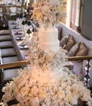 Tall Cake with Lots of Sugar Flowers
Photography: Christian Oth Studio
Read More:
http://www.insideweddings.com/weddings/traditional-chinese-tea-ceremony-glamorous-new-york-city-wedding/884/ White wedding cake with hundreds of sugar flowers and leaves cascading on cake and cake table