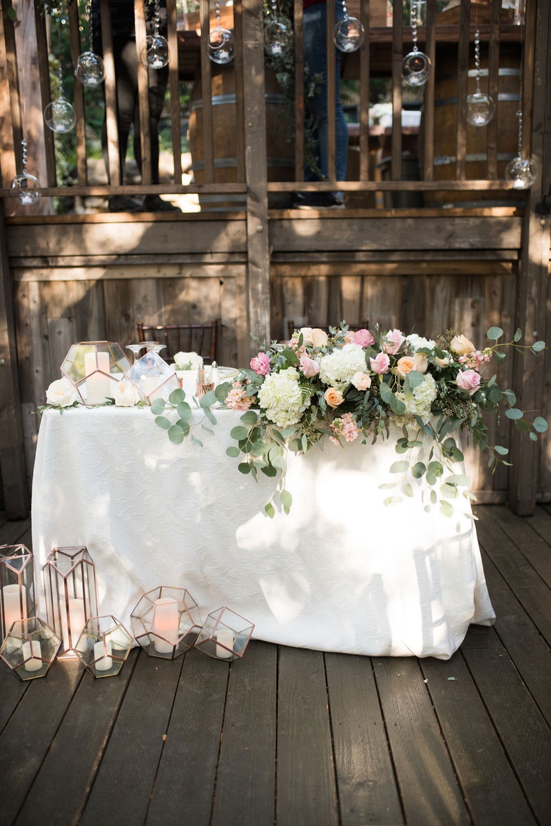 Sweetheart Table at Rustic Outdoor Wedding
Photography: Ashley Paige Photography
Read More:
http://www.insideweddings.com/weddings/elegant-outdoor-fall-wedding-at-a-rustic-chic-venue-in-malibu/1244/ wedding reception wood deck with sweetheart table terrarium gold geometric candle holders eucalyptus