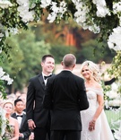 Bride %26 Groom with Officiant Under Arch
Photography: Parker J Pfister Photographer
Read More:
http://www.insideweddings.com/weddings/gorgeous-alfresco-ceremony-tented-reception-at-a-luxurious-estate/1044/ Vow exchange under flower arch greenery orchids groom in bow tie back of officiant