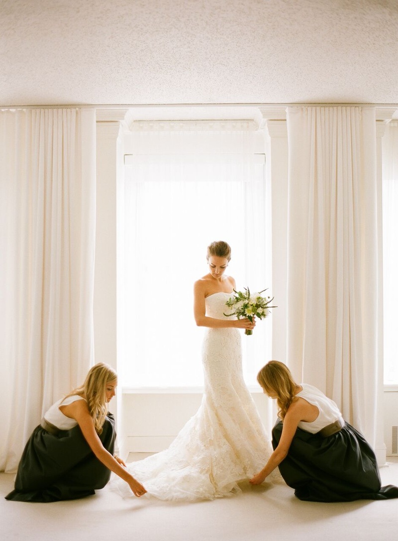 Bridesmaids Prepare Bride's Train
Photography: Eric Kelley
Read More:
http://www.insideweddings.com/weddings/summer-wedding-with-clean-color-palette-modern-design-in-chicago/776/ bridesmaids in black skirts and white tops lay out bride's vera wang gown train