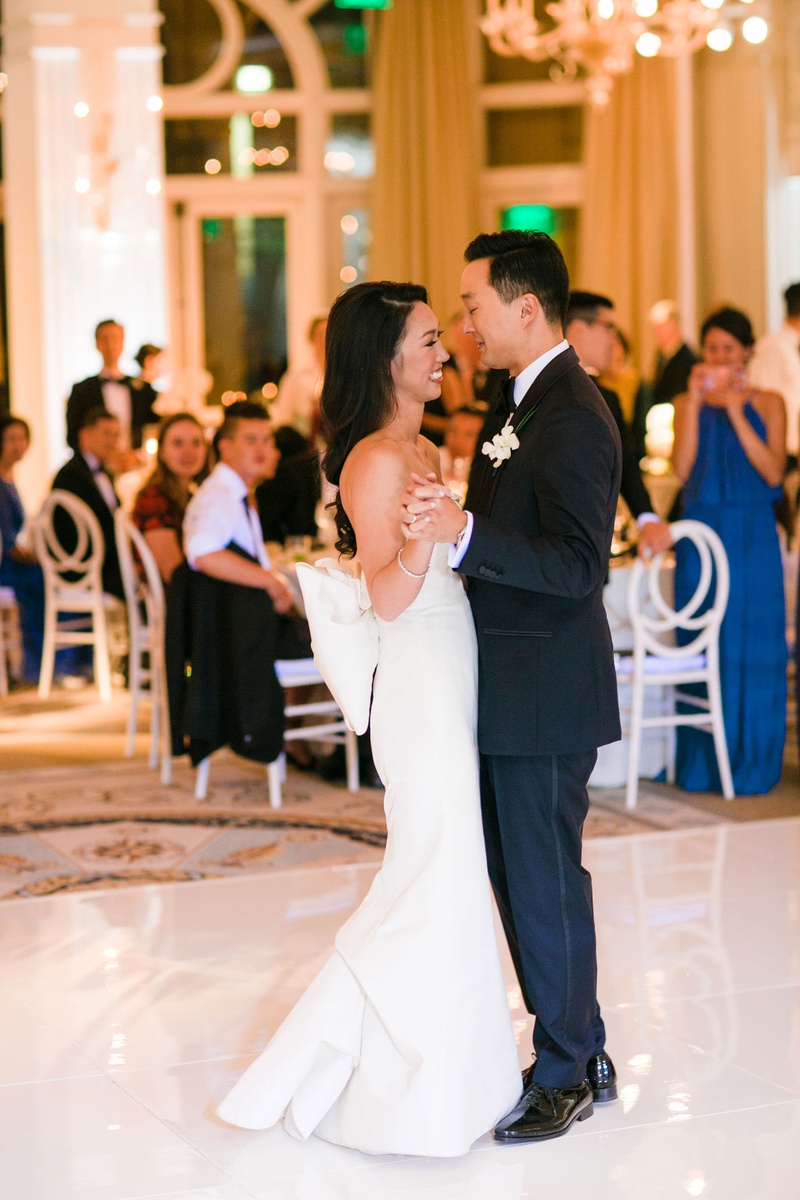 First Dance in Santa Monica Ballroom
Photography: Michelle Beller Photography
Read More:
http://www.insideweddings.com/weddings/classic-ceremony-beachfront-ballroom-reception-in-santa-monica/1234/ bride in strapless wedding dress large bow in back bustle groom in tuxedo guests watching dance