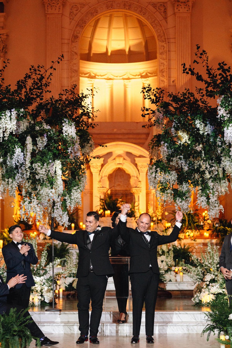 Celebrating Grooms
Photography: Fitz Carlile Photography
Read More:
http://www.insideweddings.com/weddings/luxurious-wedding-with-personalized-details-in-downtown-los-angeles/1355/ same-sex wedding inspiration, gay couple lifts arms in celebration after wedding ceremony