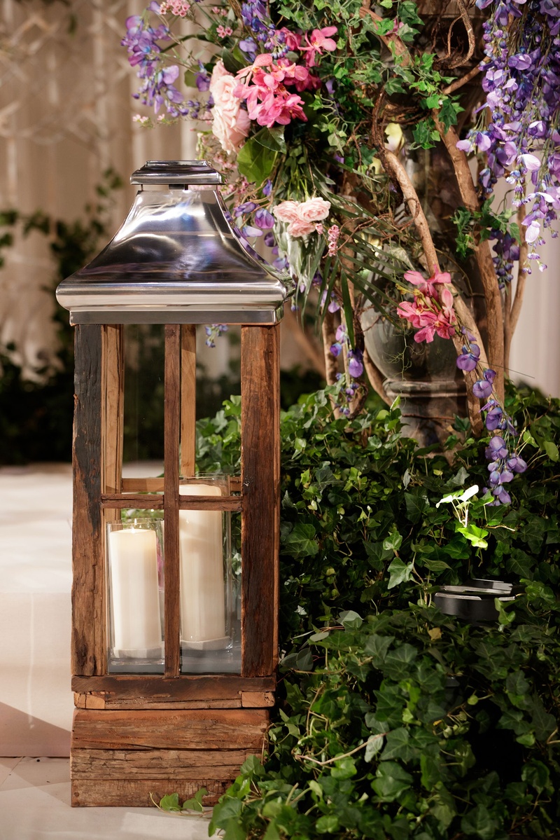 Wooden Lantern by Ivy and Flowers
Photography: Bob %26 Dawn Davis Photography
Read More:
http://www.insideweddings.com/weddings/inspiring-styled-shoot-with-deep-dark-color-palette-in-chicago/1037/ wooden lantern with chrome top and two pillar candles, ivy display with purple and pink flowers
