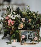 Pressed Flowers in Table Number Frame
Photography: Cadence %26 Eli Photography
Read More:
http://www.insideweddings.com/weddings/romantic-woodsy-autumn-at-home-tented-wedding-in-minnesota/1271/ wedding reception gold clear glass frame with pressed flower petals fall design motif