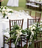 Decorated Bride and Groom Chairs
Photography: Laurie Bailey Photography
Read More:
http://www.insideweddings.com/weddings/summer-soiree-with-lush-floral-elements-in-los-angeles-california/1170/ bride and groom reception chairs decorated with greenery and ivory roses
