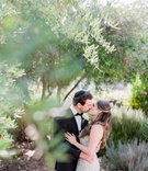 Bride and Groom Kiss Among Trees
Photography: Amy %26 Stuart Photography
Read More:
http://www.insideweddings.com/weddings/outdoor-jewish-ceremony-with-white-green-color-palette-in-ojai/1049/ bride in monique lhuillier wedding dress kisses groom in tiger in sweden tux and yarmulke