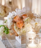 Peach Floral Arrangement
Photography: Marisa Holmes
Read More:
http://www.insideweddings.com/weddings/seafoam-ivory-hued-oceanfront-wedding-in-laguna-beach-california/431/ Floating candles and manzanita tree accents