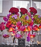 Vibrant Florals at Escort Card Table
Photography: Lindsay Muciy Photography
Read More:
http://www.insideweddings.com/weddings/vibrant-florals-dramatic-details-at-montreal-wedding/918/ red roses, purple orchids, pink hydrangeas, black escort cards and white ink