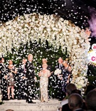 Confetti at Las Vegas-Inspired Vow Renewal
Photography: Laurie Bailey Photography
Read More:
http://www.insideweddings.com/weddings/50th-anniversary-party-a-surprise-vow-renewal-in-beverly-hills/1273/ couple at wedding ceremony vow renewal white flower chuppah chapel of the bells las vegas sign elope