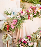 Gorgeous Outdoor Sweetheart Table
Photography: Jodee Debes Photography
Read More:
http://www.insideweddings.com/weddings/outdoor-ceremony-reception-with-bright-color-palette-at-la-ranch/1280/ sweetheart table with blush linen pink orange flowers greenery gold lanterns white settee for couple