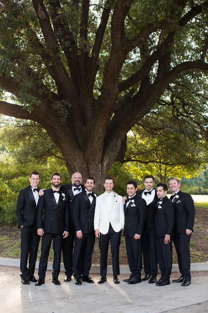 Groom in White Tuxedo with Groomsmen
Photography: Sarah Kate, Photographer
Read More:
http://www.insideweddings.com/weddings/outdoor-fall-ceremony-opulent-tented-reception-in-dallas-texas/1022/ Groom in black pants and white tuxedo bow tie with groomsmen in traditional tuxedos