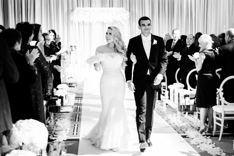 Happy Couple at Chicago Ceremony
Photography: Studio This Is
Read More:
http://www.insideweddings.com/weddings/glamorous-city-style-real-wedding-at-a-luxury-hotel-in-chicago/1217/ black and white wedding photo ceremony recessional bride in formfitting illusion gown groom in white