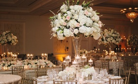 Tall Floral Centerpieces
Photography: Millie Holloman Photography
Read More:
http://www.insideweddings.com/weddings/navy-blue-gold-and-ivory-wedding-at-duke-university/558/ Indoor reception with gold chairs and cream flower arrangements
