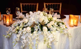 Sweetheart Table Arrangement
Photography: Hazelnut Photography
Read More:
http://www.insideweddings.com/weddings/european-influenced-autumn-wedding-in-los-angeles-california/365/ Cascading flowers over edge of white-covered table