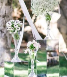 White Floral Arrangements at Alfresco Ceremony
Photography: Ryan Phillips Photography
Read More:
http://www.insideweddings.com/weddings/outdoor-ranch-wedding-with-neutral-sparkling-decor-in-california/675/ White anemones with blue centers, pink and ivory tulips, baby's breath in glass vases at outdoor alt