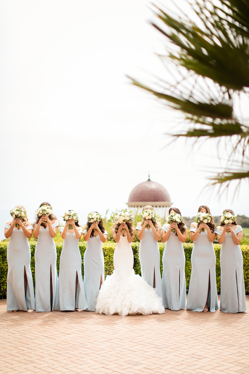 Bouquets Over Faces
Photography: Chard Photo
Read More:
http://www.insideweddings.com/weddings/alfresco-ceremony-on-the-coast-classic-ballroom-reception/1290/ bride in ines di santo, bridesmaids in light blue dessy, bouquets over faces pose
